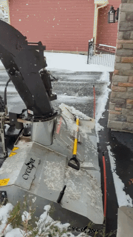 West Metro Lawn & Snow tractor snow blowing a driveway
